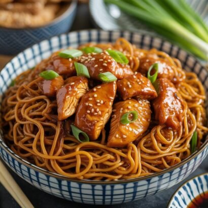 sticky garlic chicken noodles in a bowl