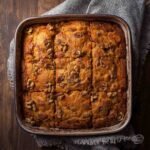A cozy square baking dish filled with carrot cake cottage cheese bake