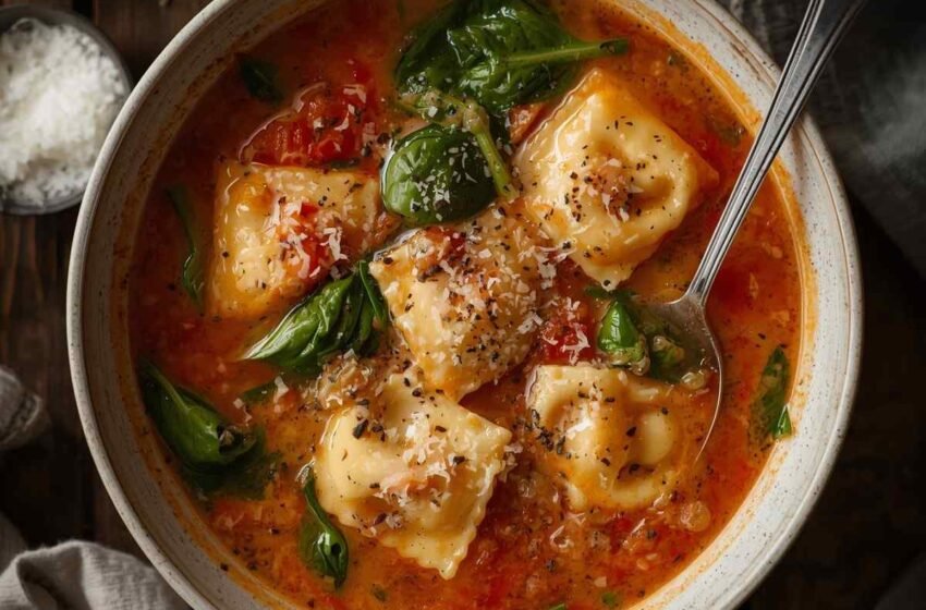 A warm bowl of creamy Tuscan ravioli soup with plump cheese ravioli
